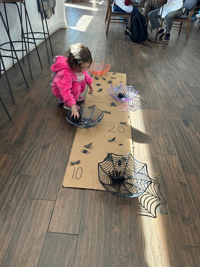 Kid playing game at Mint Coffeehouse's community halloween party