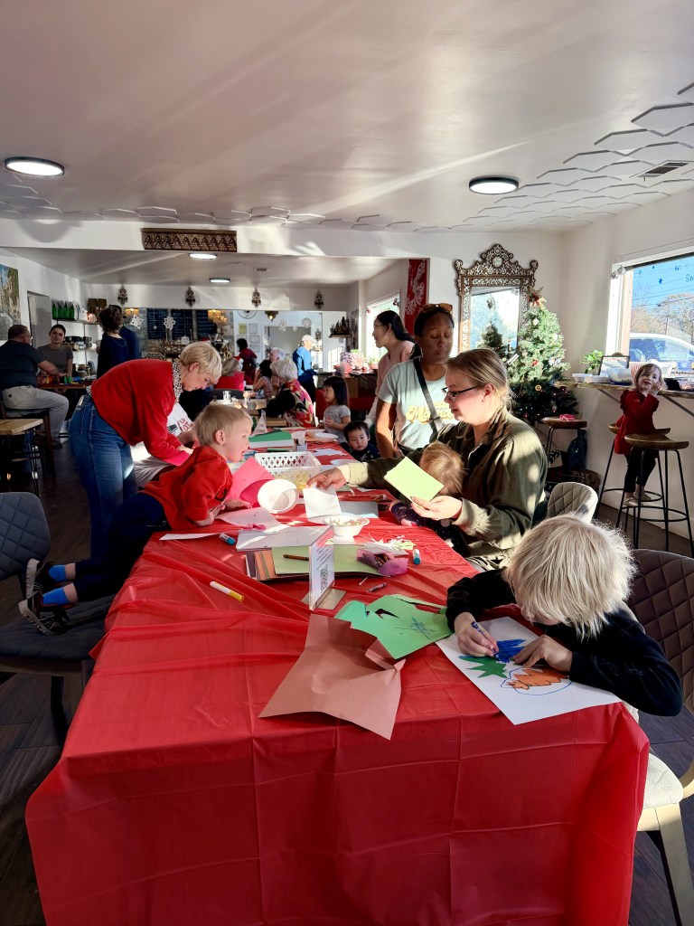 Community members making Christmas cards for a local nursing home during Mint Coffeehouse's community Christmas party
